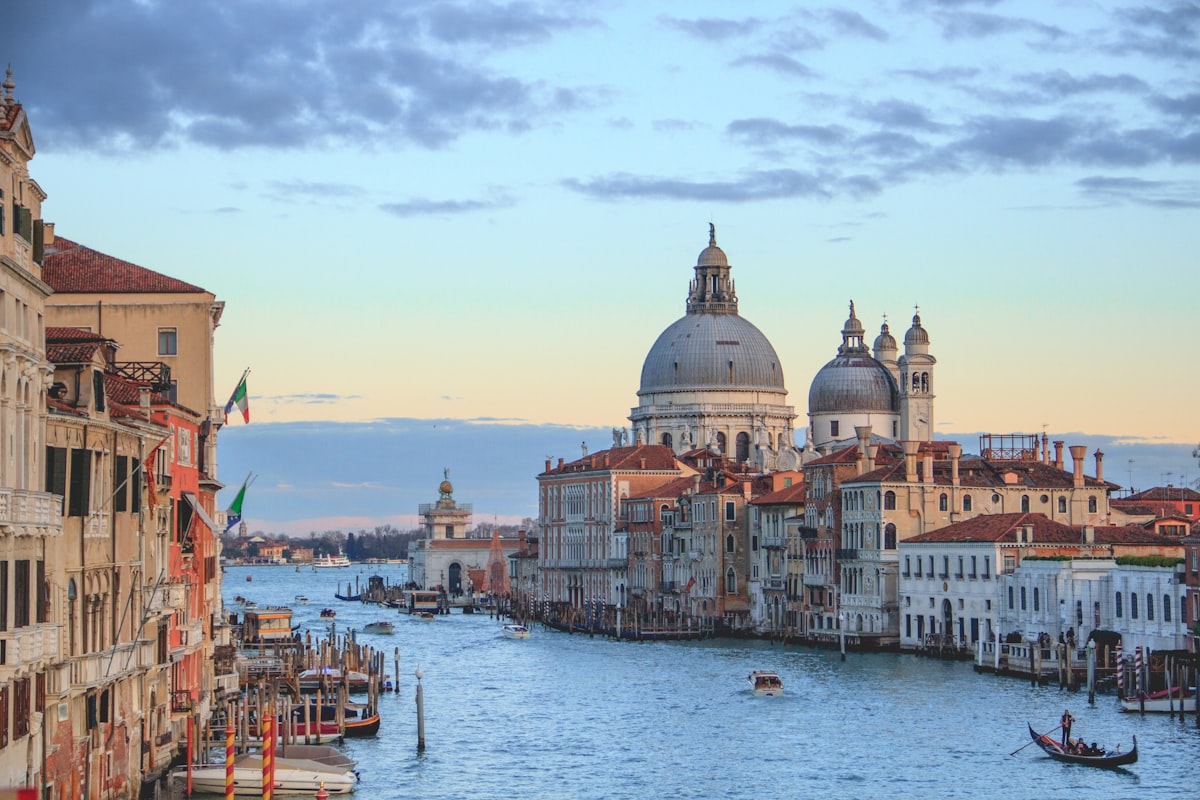 Early morning light across Venetian architecture with long shadows on stone