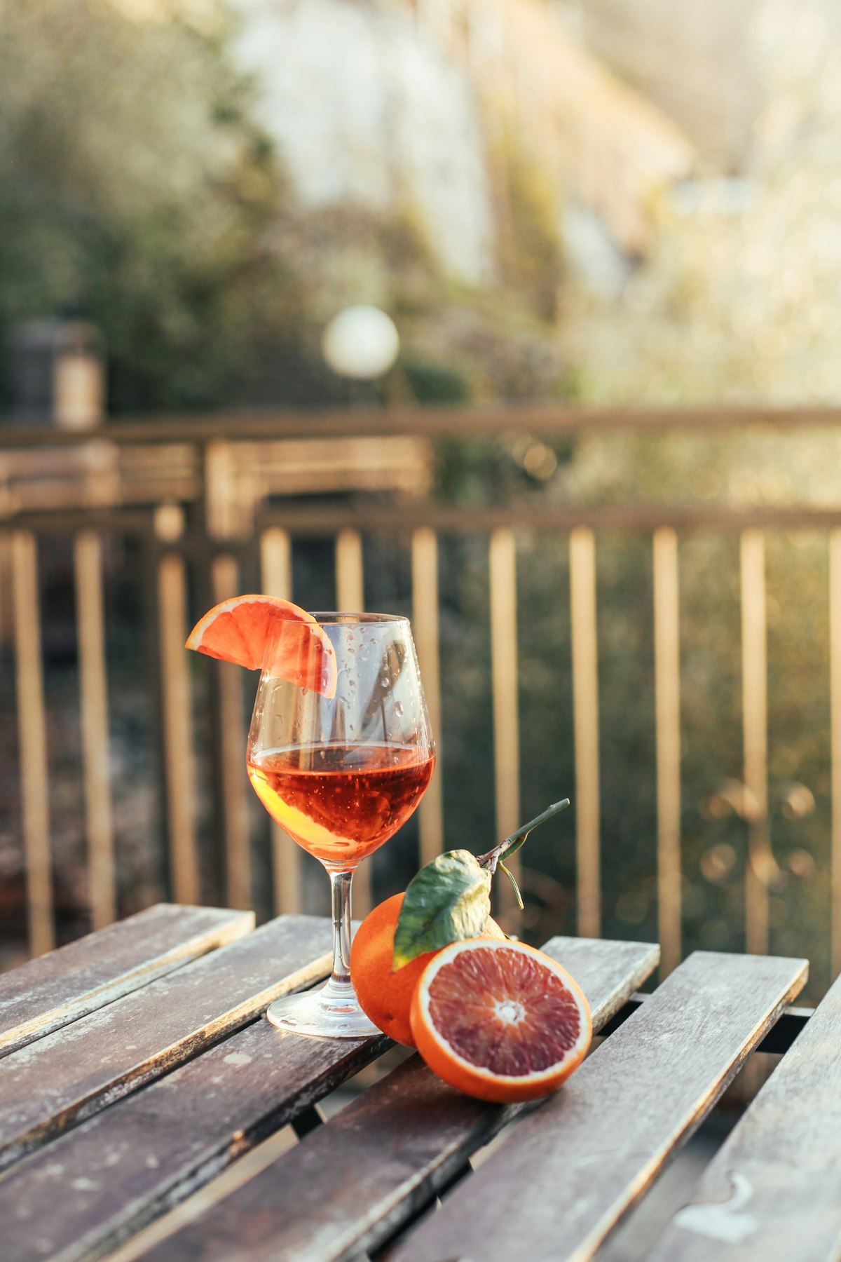 Aperol spritz in a wine glass on a canal-side table at golden hour in Venice