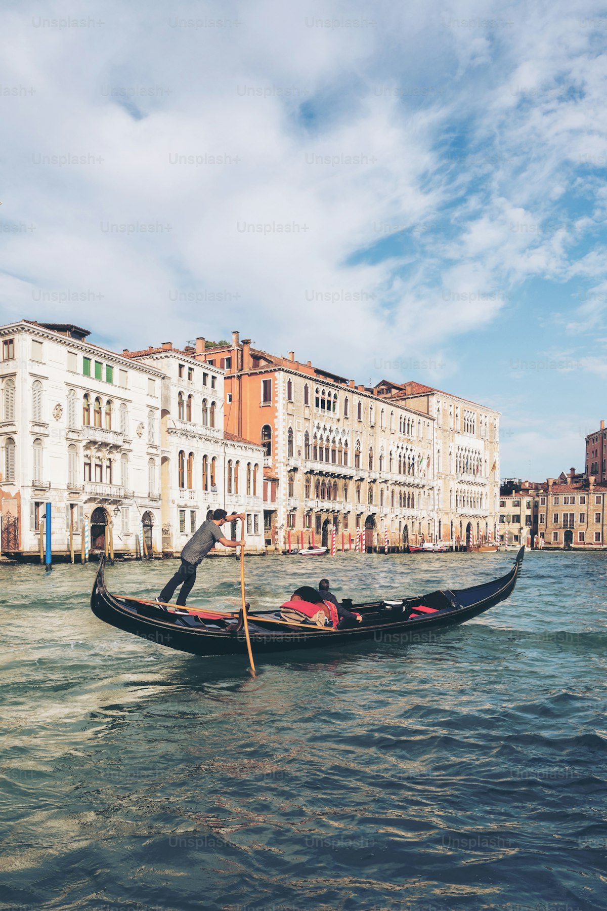 ACTV vaporetto water bus approaching a floating stop on the Grand Canal in Venice